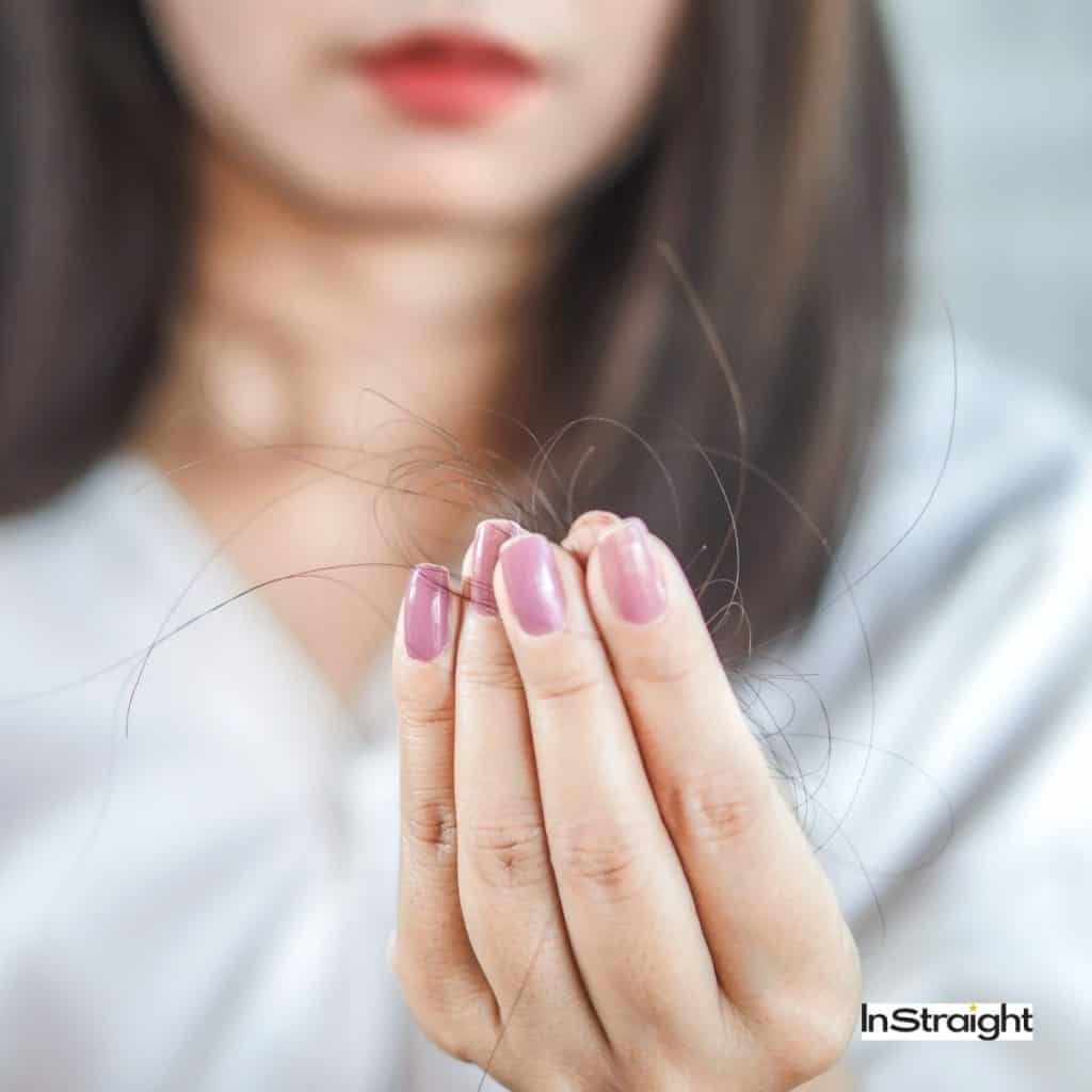 lady holding loss hair strands but do hair dryer cause hair loss ?